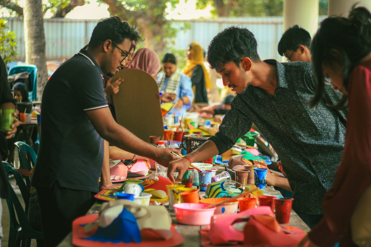 Students engaging in a vibrant art workshop at Dhaka University, showcasing creativity and collaboration.